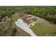 Aerial view featuring a home with a screened-in patio and detached garage at 18216 Monteverde Dr, Spring Hill, FL 34610