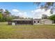 Spacious backyard featuring a screened-in patio, shed, and well-maintained lawn at 18216 Monteverde Dr, Spring Hill, FL 34610