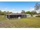 Spacious backyard featuring a screened-in patio, shed, and well-maintained lawn at 18216 Monteverde Dr, Spring Hill, FL 34610