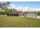 Spacious backyard featuring a screened-in patio, shed, and well-maintained lawn at 18216 Monteverde Dr, Spring Hill, FL 34610