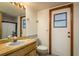 Bright bathroom features a wood vanity, neutral tile, and updated fixtures at 18216 Monteverde Dr, Spring Hill, FL 34610