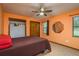 Bedroom with a ceiling fan, a bed, and two closets illuminated by natural light from a window at 18216 Monteverde Dr, Spring Hill, FL 34610