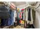 Walk-in closet featuring metal racks, hanging clothes, personal accessories, and wooden floor in neutral color at 18216 Monteverde Dr, Spring Hill, FL 34610