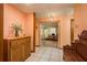 Inviting entryway with tile flooring, a wooden cabinet, and a view of a home office through a doorway at 18216 Monteverde Dr, Spring Hill, FL 34610