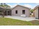 The exterior of the home shows a screened patio, concrete pad, and white deck box at 18216 Monteverde Dr, Spring Hill, FL 34610