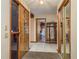 Welcoming foyer features tile flooring, decorative front door, mirrored closet, and views into the home at 18216 Monteverde Dr, Spring Hill, FL 34610