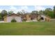 Attractive single-story home boasting stucco exterior, rock accents, manicured lawn, and mature landscaping at 18216 Monteverde Dr, Spring Hill, FL 34610