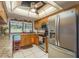 Well-lit kitchen featuring granite countertops, stainless steel appliances, and a large window overlooking the backyard at 18216 Monteverde Dr, Spring Hill, FL 34610