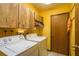 Laundry room features full size washer and dryer, storage cabinets, and a wooden door at 18216 Monteverde Dr, Spring Hill, FL 34610