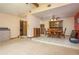Expansive view of combined rooms with dining set, television, and open access to the front entryway at 18216 Monteverde Dr, Spring Hill, FL 34610