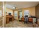 Office space with hardwood-look flooring, fan, natural light and wooden desk and cabinets at 18216 Monteverde Dr, Spring Hill, FL 34610