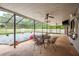 Spacious screened patio with outdoor seating area, ceiling fans, and views of the backyard at 18216 Monteverde Dr, Spring Hill, FL 34610