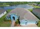 Overhead view of the home showcasing its location near a lake and the surrounding lush greenery at 19879 Tattnall Way, Brooksville, FL 34601
