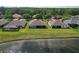 Aerial view of backyard, lake, and neighboring houses, showcasing outdoor living at 19879 Tattnall Way, Brooksville, FL 34601
