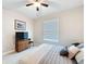 Serene bedroom with a cozy bed, ceiling fan, and a TV stand offering a comfortable and inviting space at 19879 Tattnall Way, Brooksville, FL 34601