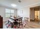Dining room area with wood table, patterned rug, and window view at 19879 Tattnall Way, Brooksville, FL 34601