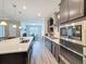 Kitchen area with a large island, stainless steel appliances, and dark wood cabinets at 19879 Tattnall Way, Brooksville, FL 34601