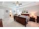 Spacious main bedroom with tray ceiling, ceiling fan, and ensuite bath at 19879 Tattnall Way, Brooksville, FL 34601