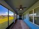 Covered patio with ceiling fans, textured rug and a view of the pond at 19879 Tattnall Way, Brooksville, FL 34601