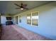 Cozy enclosed porch with ceiling fans and scenic lake view, ideal for outdoor lounging and relaxation at 19879 Tattnall Way, Brooksville, FL 34601