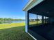 Screened patio with water view, outdoor living space and lush lawn at 19879 Tattnall Way, Brooksville, FL 34601