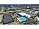 Aerial view of complex with a pool, solar array and parking at 2221 Swedish Dr # 15, Clearwater, FL 33763