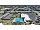 Aerial view of complex with a pool, solar array and parking at 2221 Swedish Dr # 15, Clearwater, FL 33763