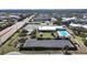 Aerial view of complex with a pool, solar array and parking at 2221 Swedish Dr # 15, Clearwater, FL 33763