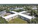 Stunning aerial view of a meticulously planned residential building surrounded by lush greenery and a serene pond at 2221 Swedish Dr # 15, Clearwater, FL 33763