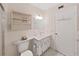 Cozy bathroom with sink, mirror, toilet, and shower with sliding glass door at 2221 Swedish Dr # 15, Clearwater, FL 33763