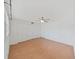 Bedroom with hardwood floors, a ceiling fan, and a closet with sliding doors at 2221 Swedish Dr # 15, Clearwater, FL 33763