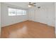 Bedroom featuring a window, hardwood floors and a closet with sliding doors at 2221 Swedish Dr # 15, Clearwater, FL 33763
