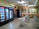 Dining area of a restaurant features tables, chairs, and refrigerated food display at 2221 Swedish Dr # 15, Clearwater, FL 33763