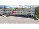 Exterior of a condo building with ample parking, well maintained lawns, and second story balconies at 2221 Swedish Dr # 15, Clearwater, FL 33763