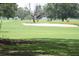 Scenic view of a lush golf course with a sand trap and mature trees at 2221 Swedish Dr # 15, Clearwater, FL 33763
