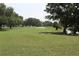 Scenic view of a lush green golf course with mature trees and sand traps at 2221 Swedish Dr # 15, Clearwater, FL 33763