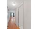 Hallway with tile flooring to bathroom and wood flooring leading to bedroom with natural light at 2221 Swedish Dr # 15, Clearwater, FL 33763