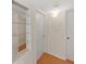 Hallway with hardwood floors, multiple doors, and a built-in shelving unit at 2221 Swedish Dr # 15, Clearwater, FL 33763