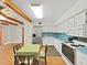 Bright eat-in kitchen with stainless steel refrigerator, white cabinets, and light blue countertops at 2221 Swedish Dr # 15, Clearwater, FL 33763