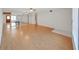 Bright living room with hardwood floors, ceiling fan, mirrored wall, and neutral paint at 2221 Swedish Dr # 15, Clearwater, FL 33763