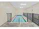 Indoor pool area with tile floor, safety railings and great light at 2221 Swedish Dr # 15, Clearwater, FL 33763
