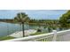 Canal view showcasing backyard with patio and dock, surrounded by lush tropical landscaping at 3415 Holly Springs Dr, Hernando Beach, FL 34607
