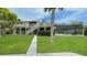Charming home exterior showcasing the front lawn, pool, and an outdoor staircase at 3415 Holly Springs Dr, Hernando Beach, FL 34607