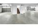 Large garage interior with multiple garage doors, access stairs, and ample open space at 3415 Holly Springs Dr, Hernando Beach, FL 34607