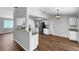Well-lit kitchen with stainless steel appliances, white cabinetry, and laminate flooring at 3415 Holly Springs Dr, Hernando Beach, FL 34607