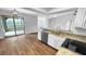 Bright kitchen featuring granite counters, stainless steel appliances, and an adjacent sunroom at 3415 Holly Springs Dr, Hernando Beach, FL 34607