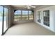 Enclosed lanai with multiple windows and a ceiling fan, offering serene outdoor views at 3415 Holly Springs Dr, Hernando Beach, FL 34607