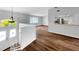 Bright living room featuring laminate floors, white walls, a fan and staircase at 3415 Holly Springs Dr, Hernando Beach, FL 34607