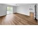 Spacious living room with sliding door access to lanai and a ceiling fan at 3415 Holly Springs Dr, Hernando Beach, FL 34607