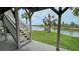 Charming outdoor area with stairs, a patio, and lush tropical landscaping on the water at 3415 Holly Springs Dr, Hernando Beach, FL 34607